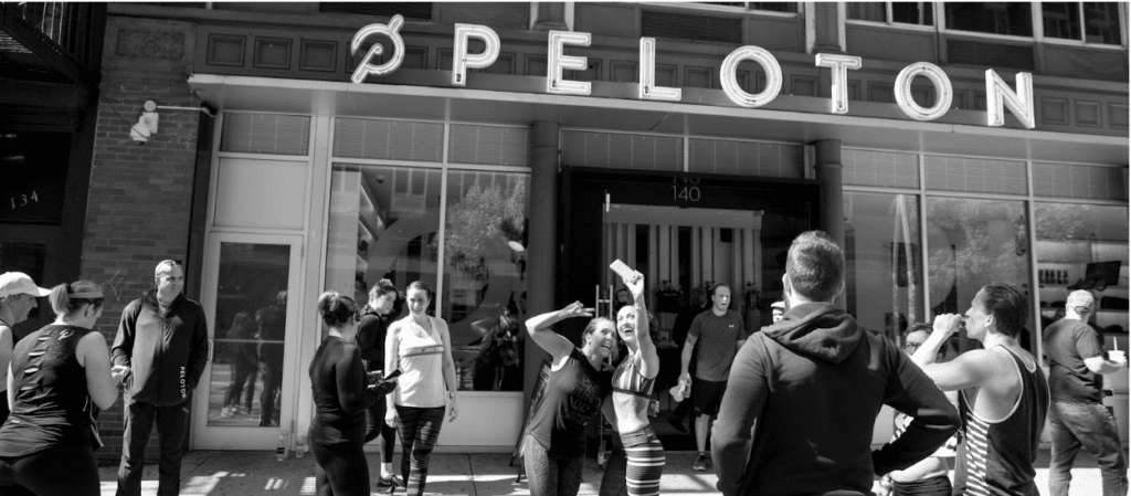 People gathered and taking pictures outside a Peloton store