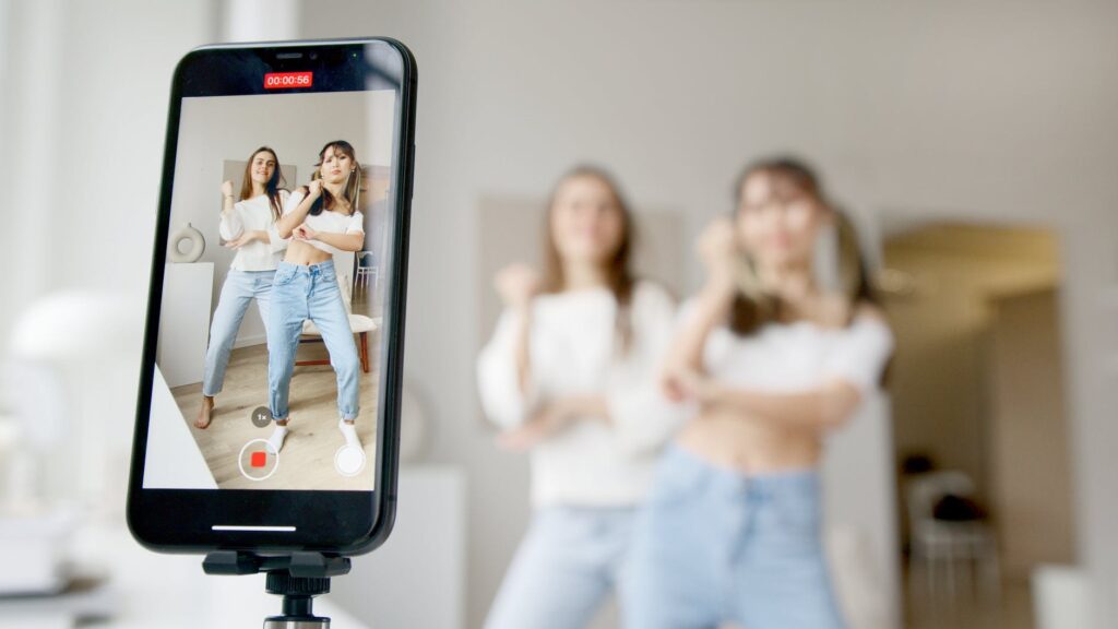 Two brand ambassadors filming themselves dancing on a phone