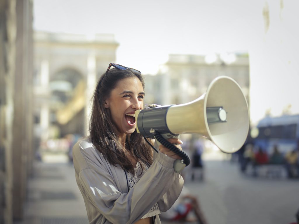 woman speaking into a megaphone