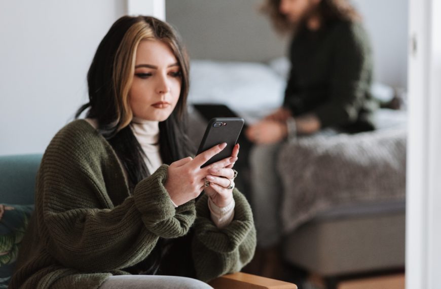 woman sitting using smart phone