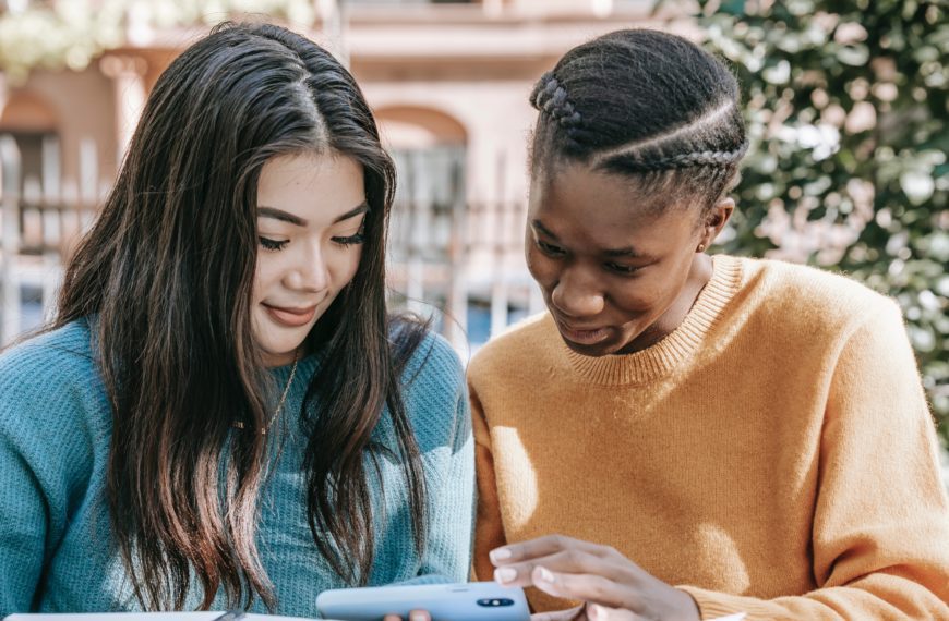 Two women looking at a phone screen