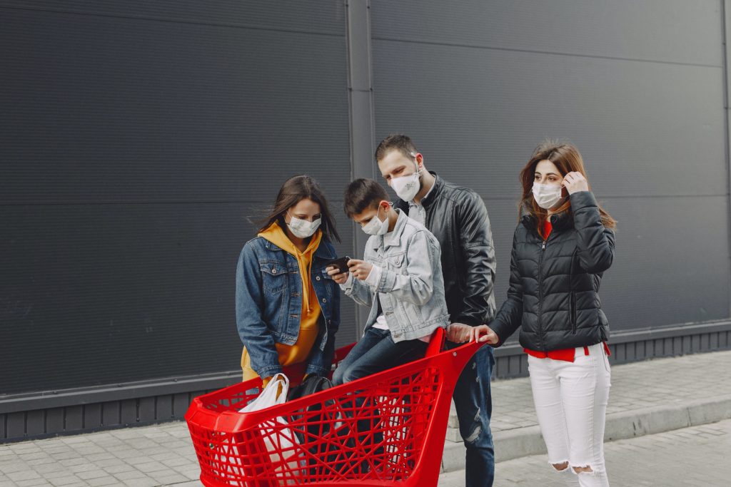 A family shopping wearing masks