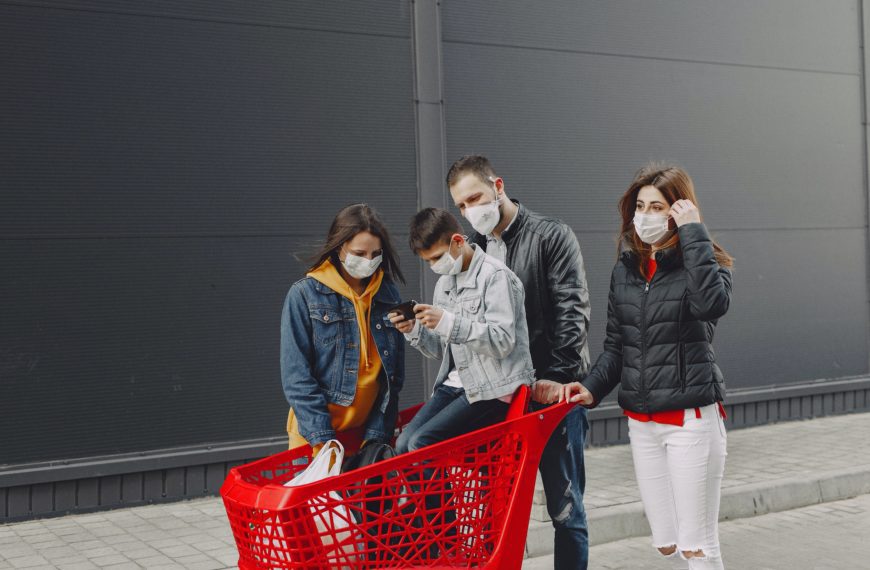 A family shopping wearing masks